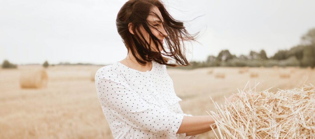 a women in a corn field looking relaxed